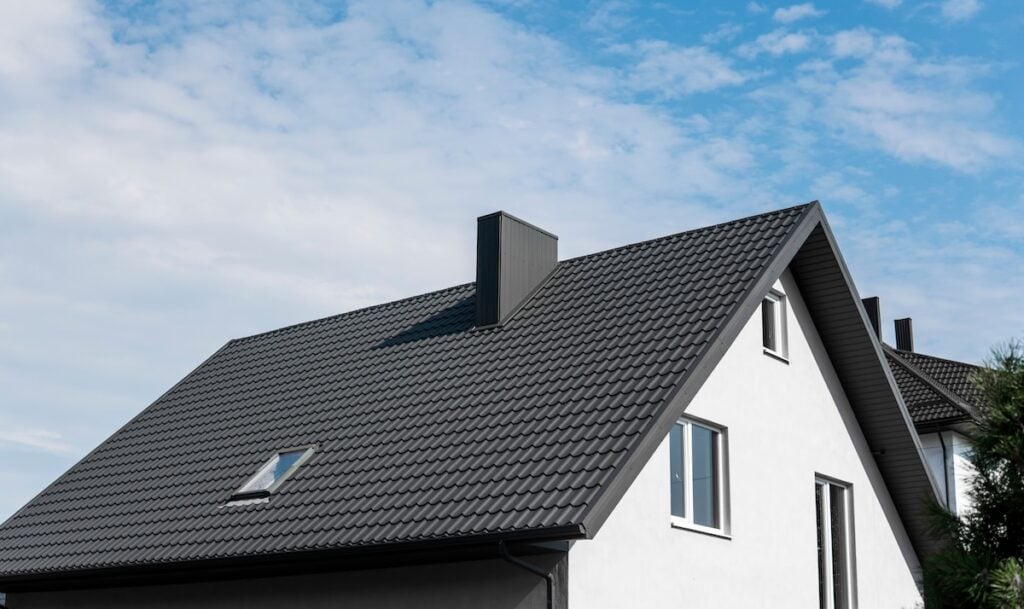 Modern gable roof covered with tile effect PVC coated brown metal roof sheets
