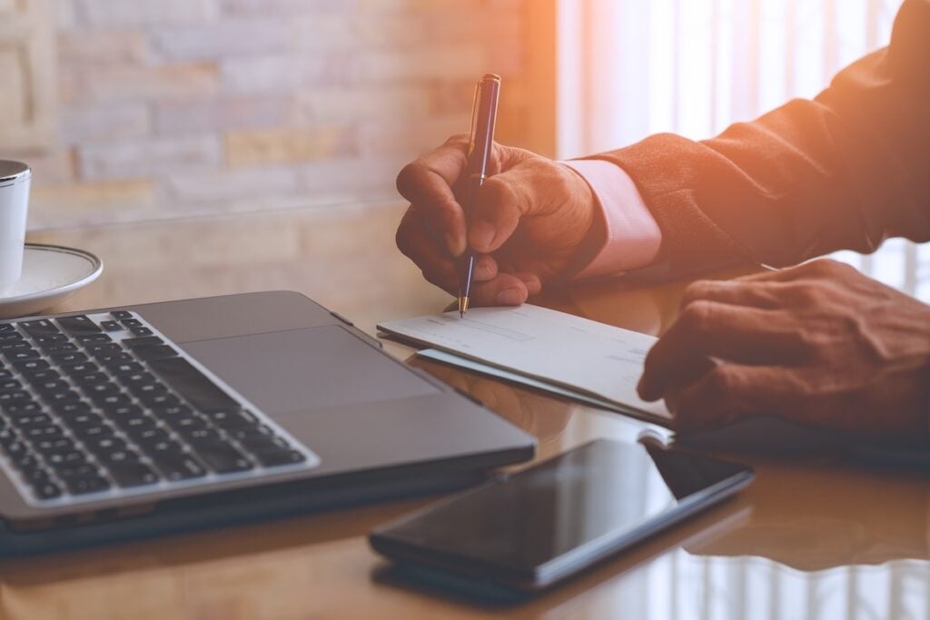 man writing a check