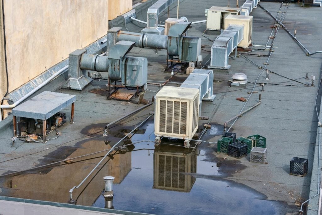 Air conditioning systems on roof of commercial buildings. The rooftop location benefits from less noise pollution, minimize dirt and damage, increased security, space savings and ease of maintenance