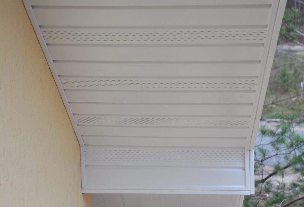 Plastic white uPVC soffit board below the facia of the roof. soffit vents