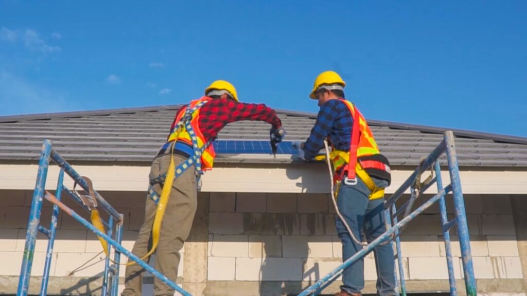 commercial roof maintenance two workers standing on platform