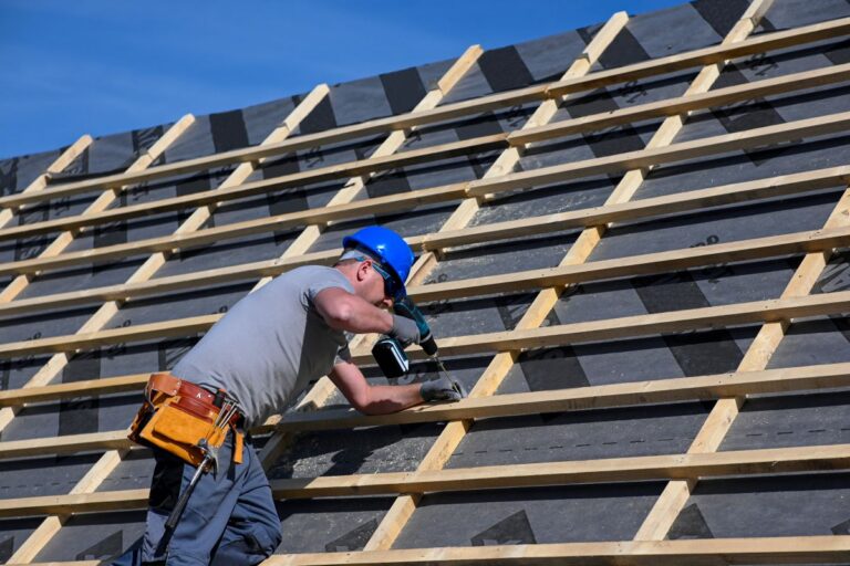 commercial roof replacement worker installing wooden structure