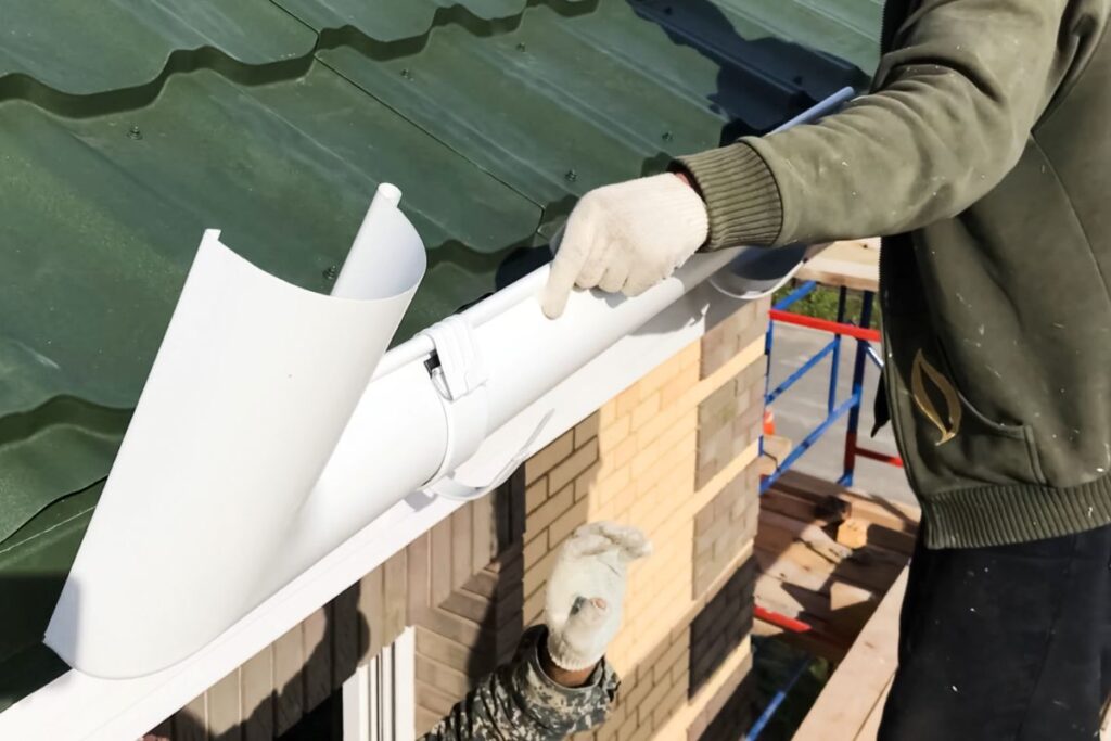 how long do gutters last worker repairing white water system