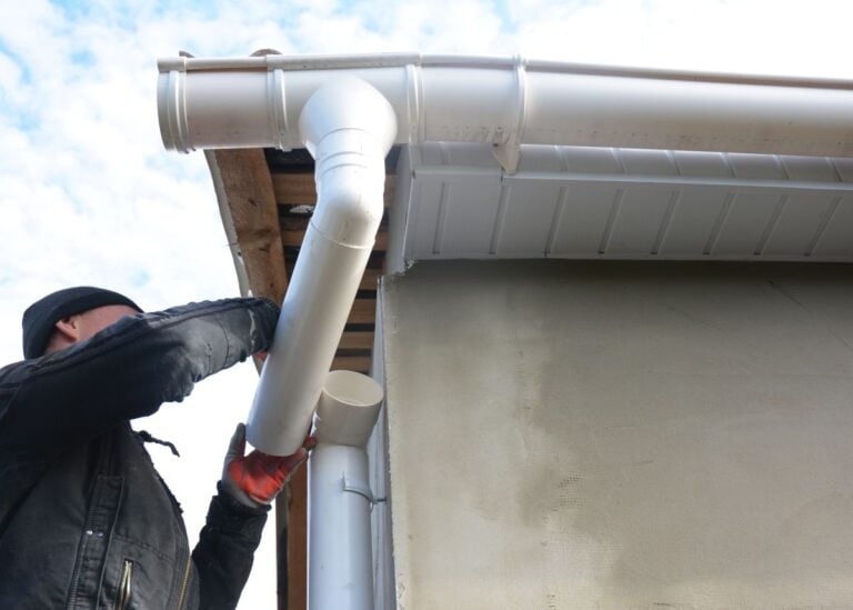 rain gutter repair worker installing white water system