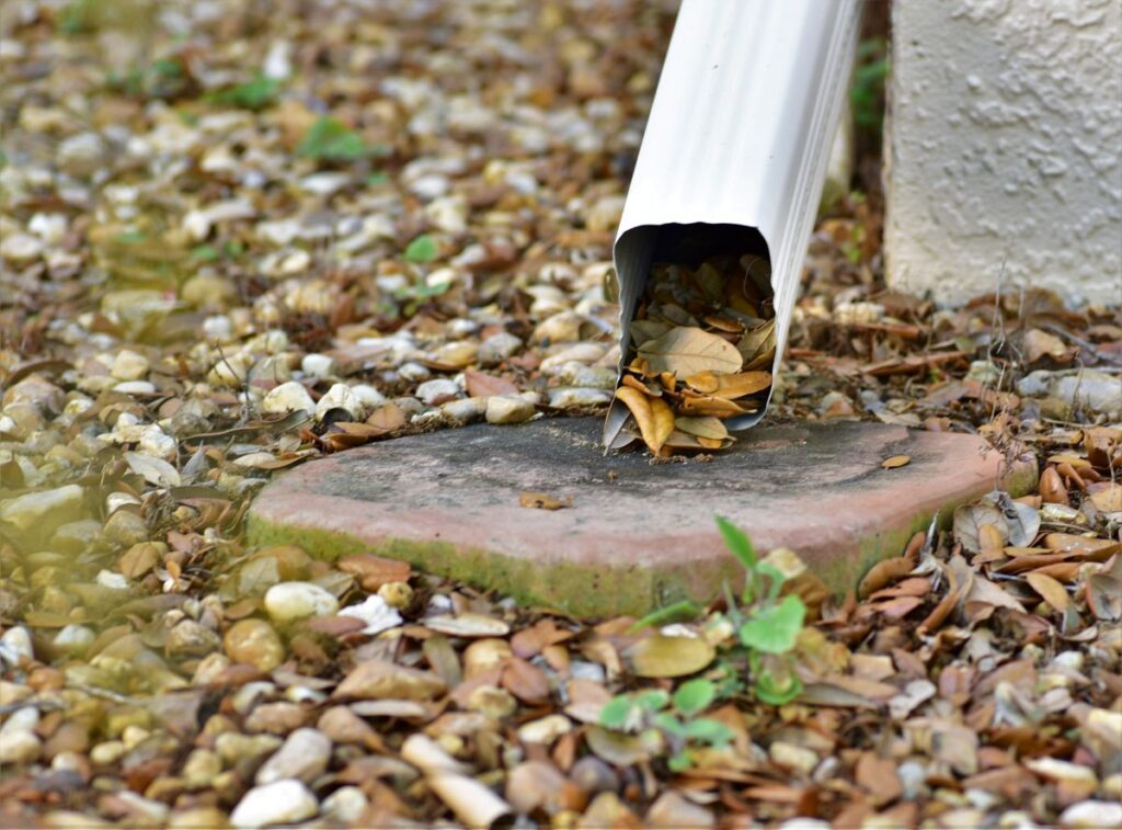 rain gutter repair stones and leaves on the floor