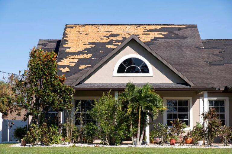 storm damage insurance claim big house with shingles roof