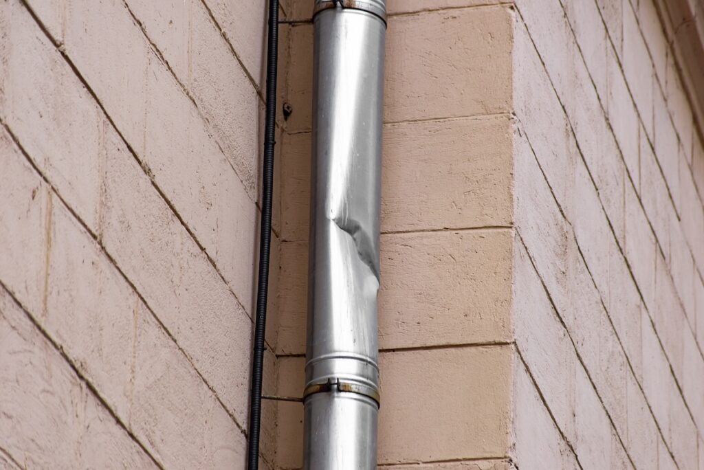 Crumpled drainpipe and corrugated hose