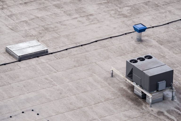 The external units of the commercial air conditioning and ventilation systems are installed on the roof of an industrial building
