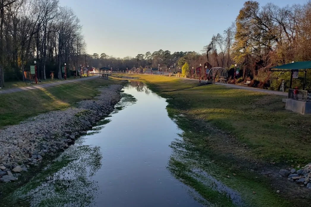 Creek, walking paths and playground at Sandy Creek Park in Jasper, Texas.