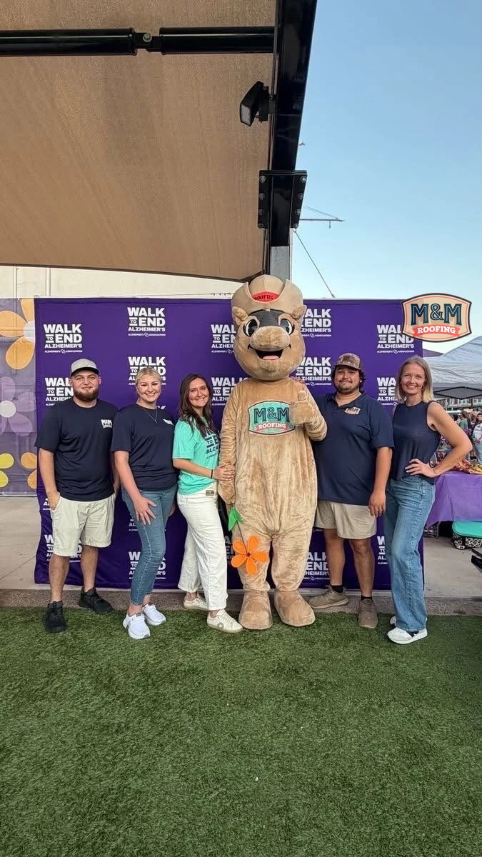 M&M Roofing’s Roofus mascot with a group at a Walk to End Alzheimer’s community event