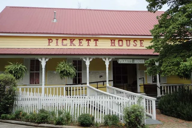Pickett House sign and porch at Heritage Village near Woodville, Texas.